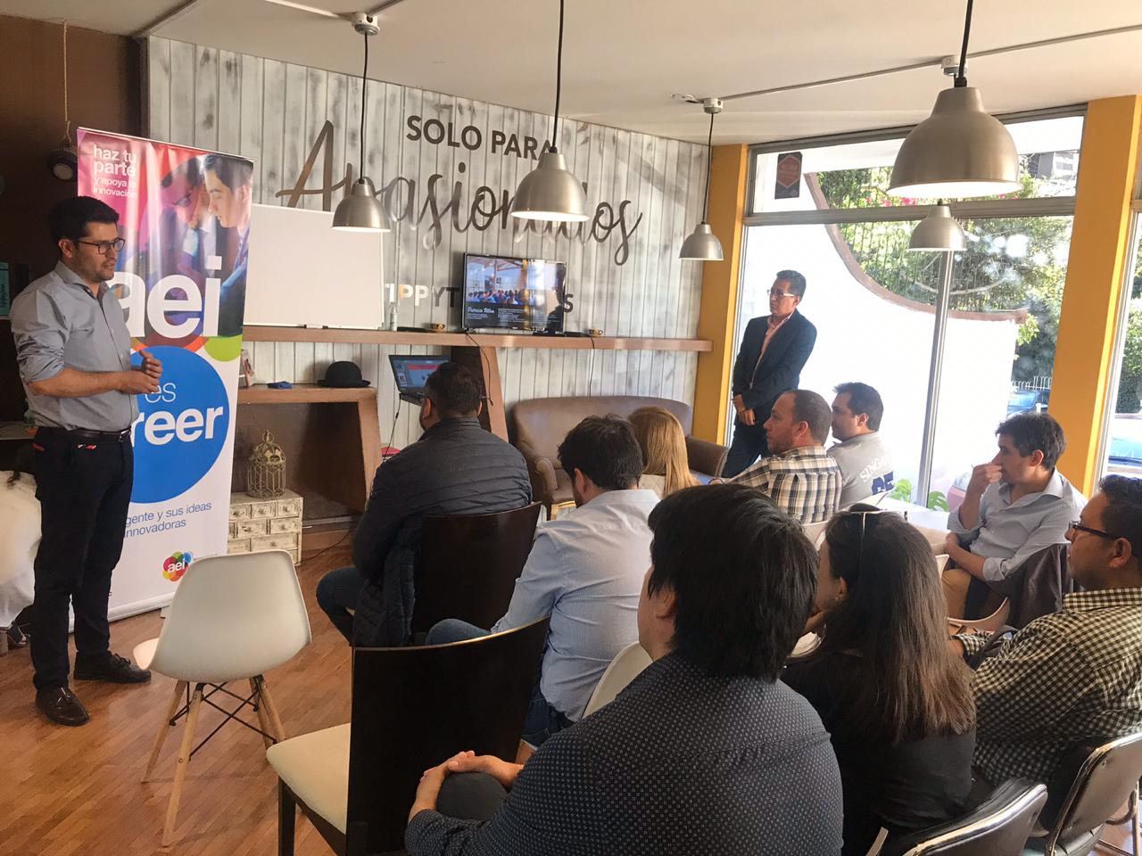 Entrepreneur presents his startup to audience at coworking space in Quito, Ecuador.
