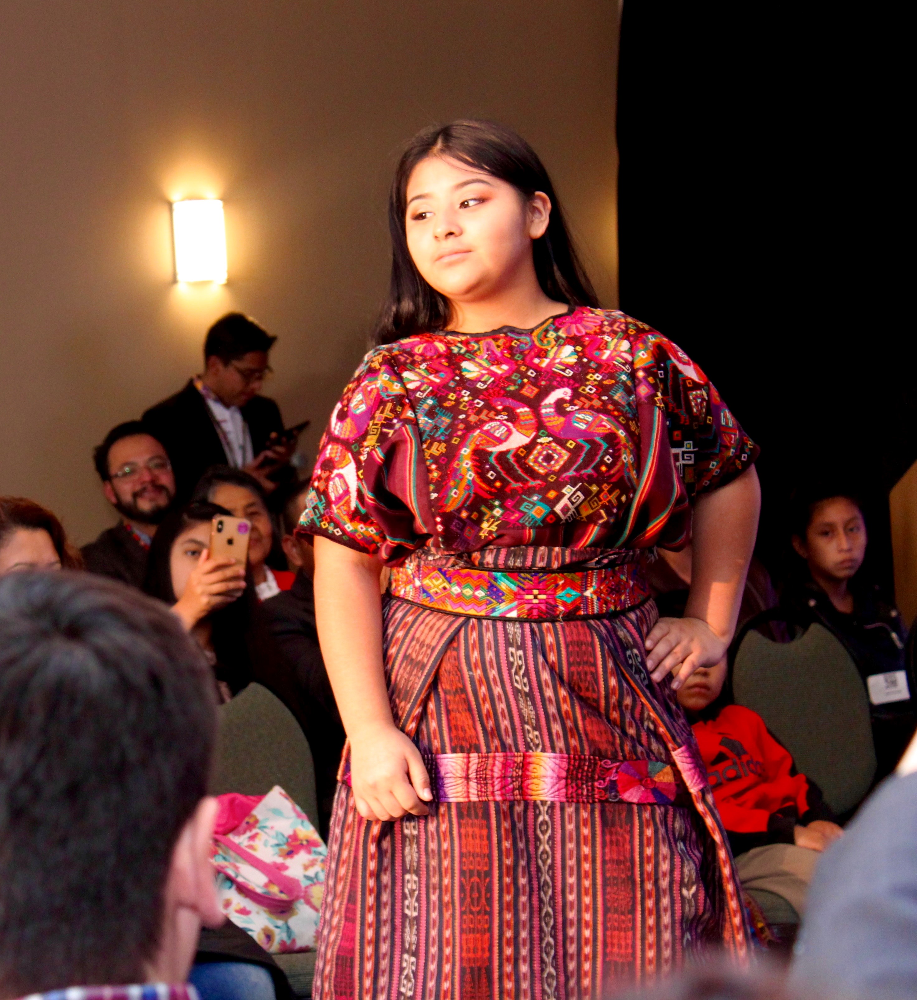 Girl modeling red Guatemalan dress