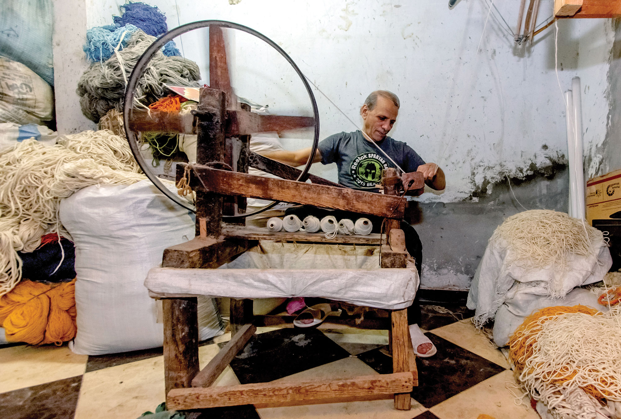 Man spinning thread.