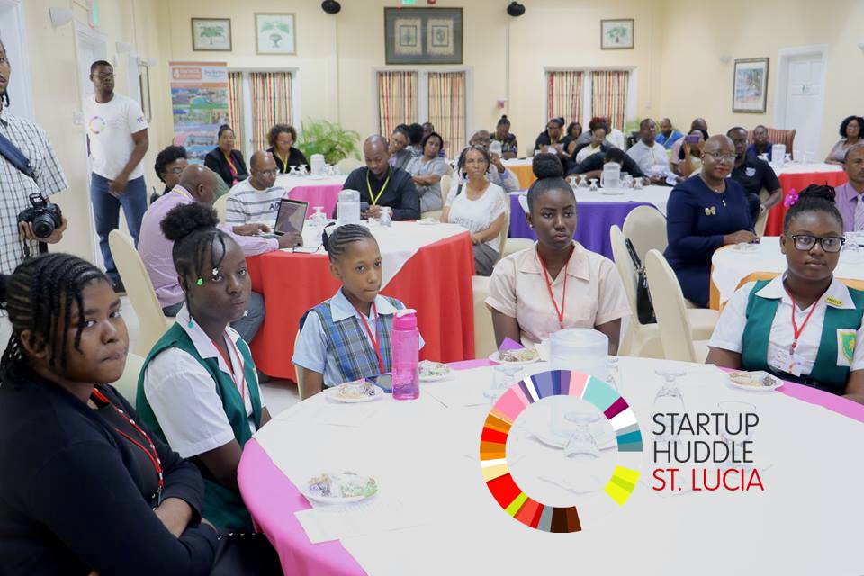 Startup Huddle St. Lucia. Audience listening intently to announcements.