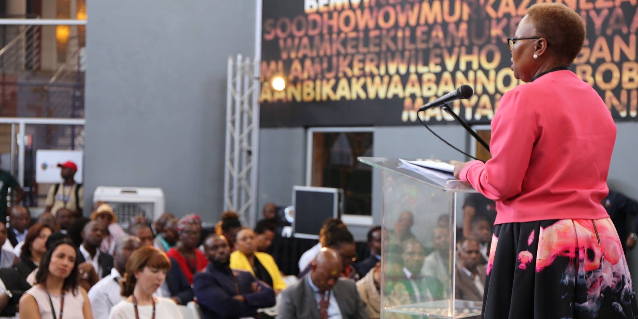 Woman speaking at podium to crowd at 22 On Sloane in Johannesburg, South Africa.