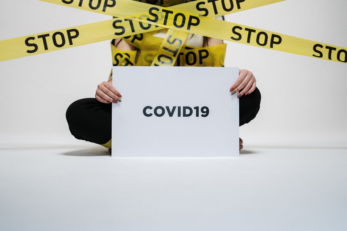 cottonbro - https://www.pexels.com/photo/person-holding-covid-sign-3951600/