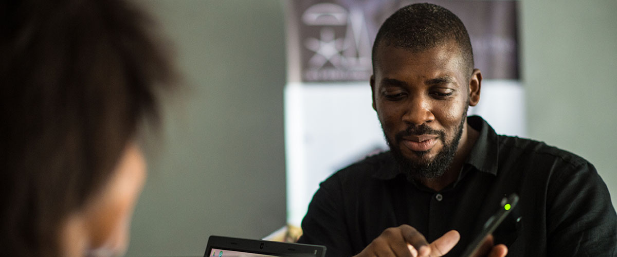 Benin man demonstrates a mobile business app. /  © Government of Benin