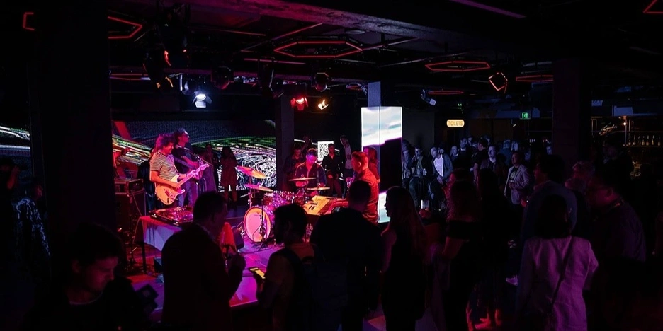 A group of people listening to a live band