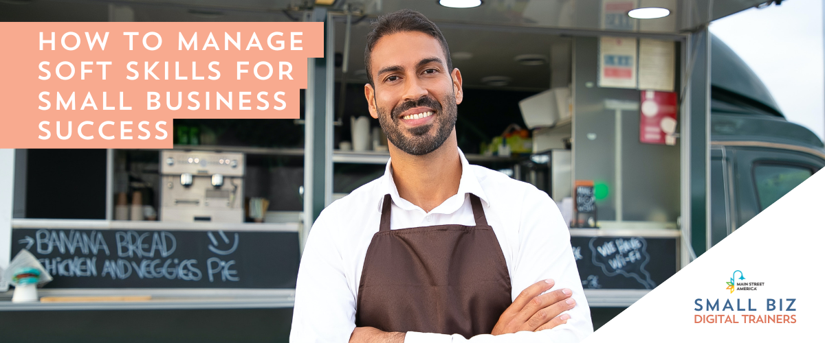 Man wearing brown apron and white shirt crosses arms and smiles in front of food truck