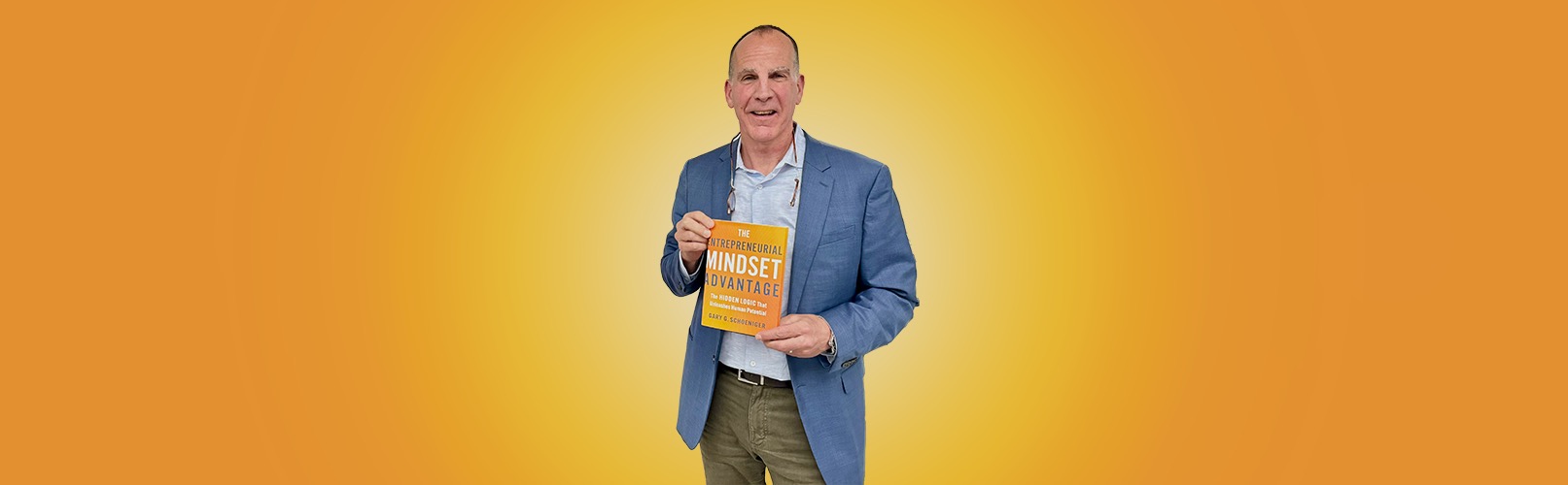 Author Gary Schoeniger holding The Entrepreneurial Mindset Advantage