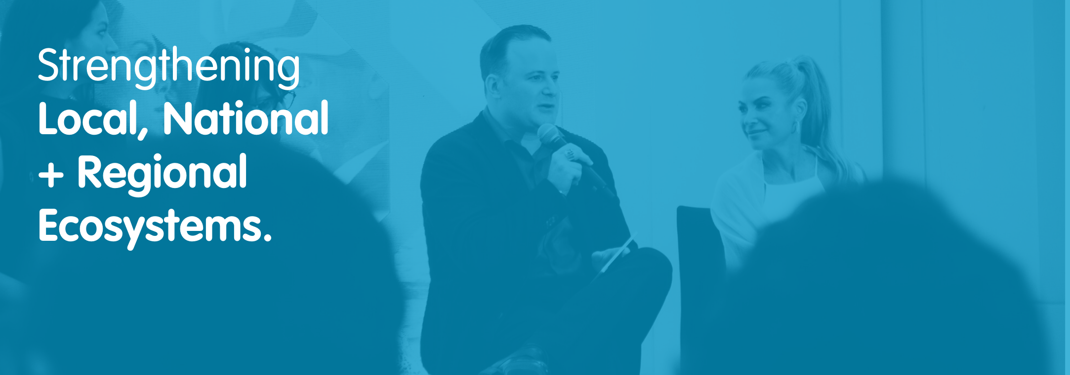 two panelists speaking on stage