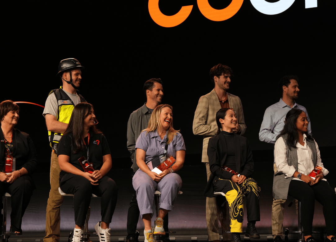 Group of entrepreneurs sitting on stage, smiling