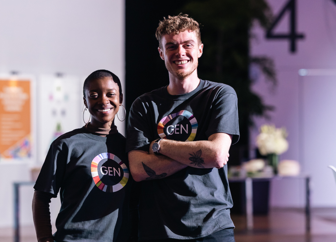 two people facing camera and smiling