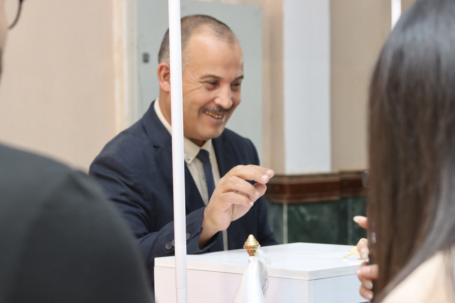 Image of the University Director placing the first idea form into the Idea Box as part of the Global Entrepreneurship Week activities.