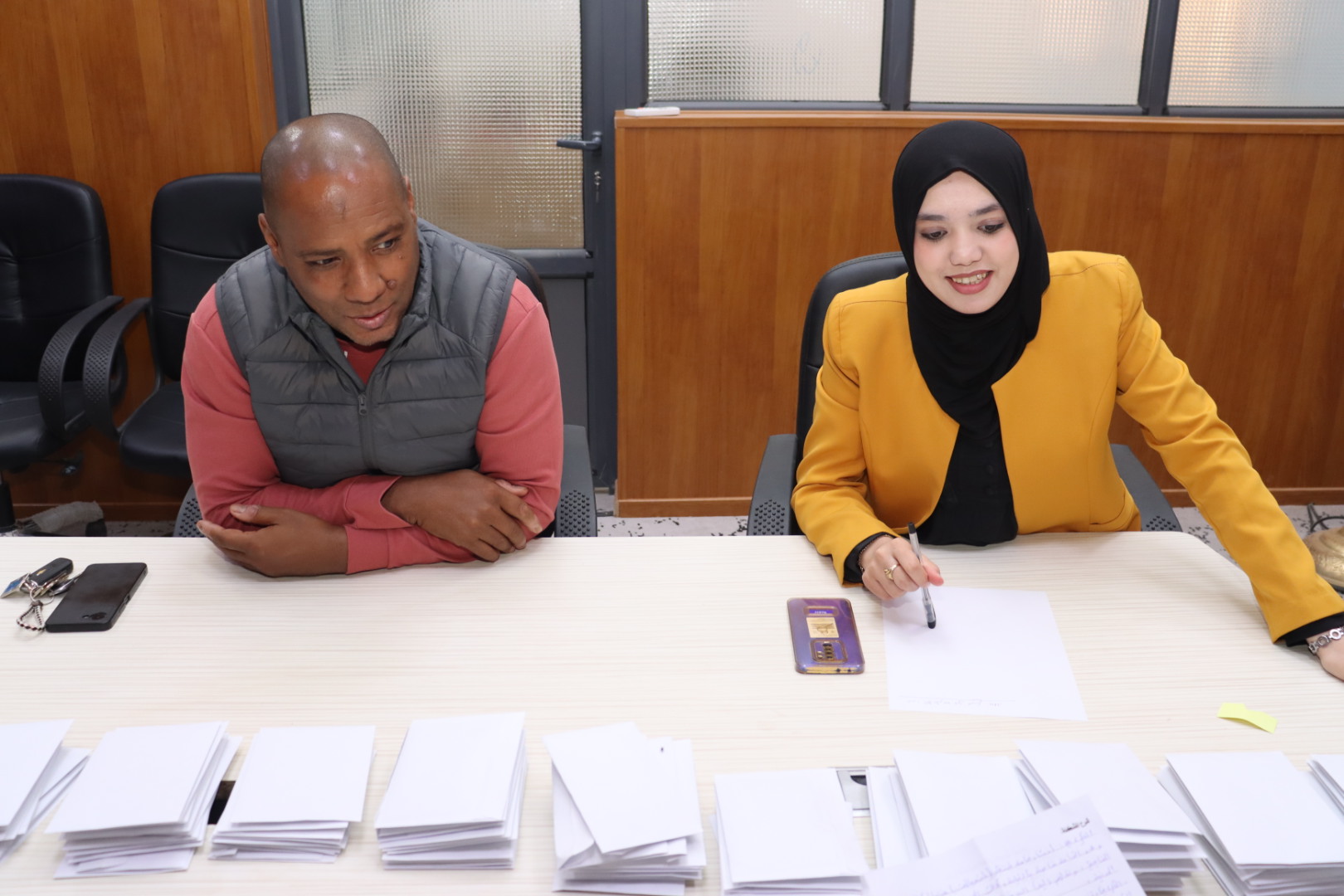 2️⃣ Image showing committee members reviewing and discussing student proposals.