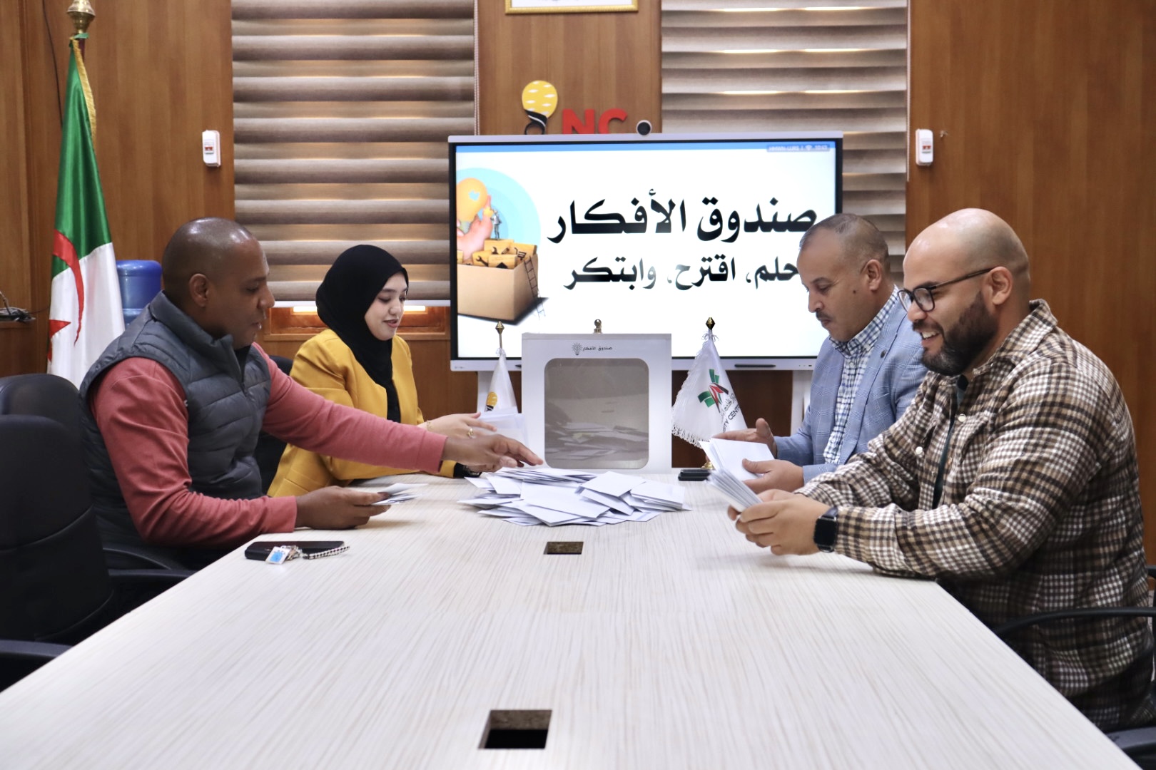 2️⃣ Image showing committee members reviewing and discussing student proposals.