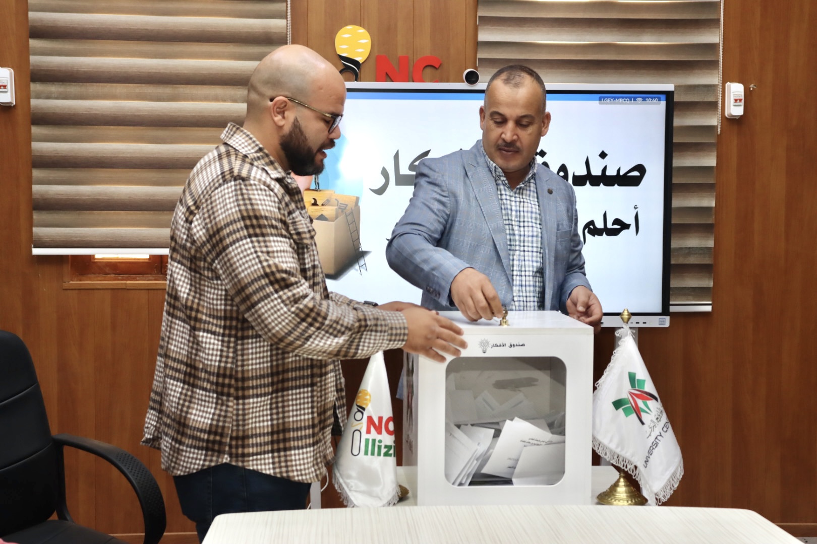 2️⃣ Image showing committee members reviewing and discussing student proposals.