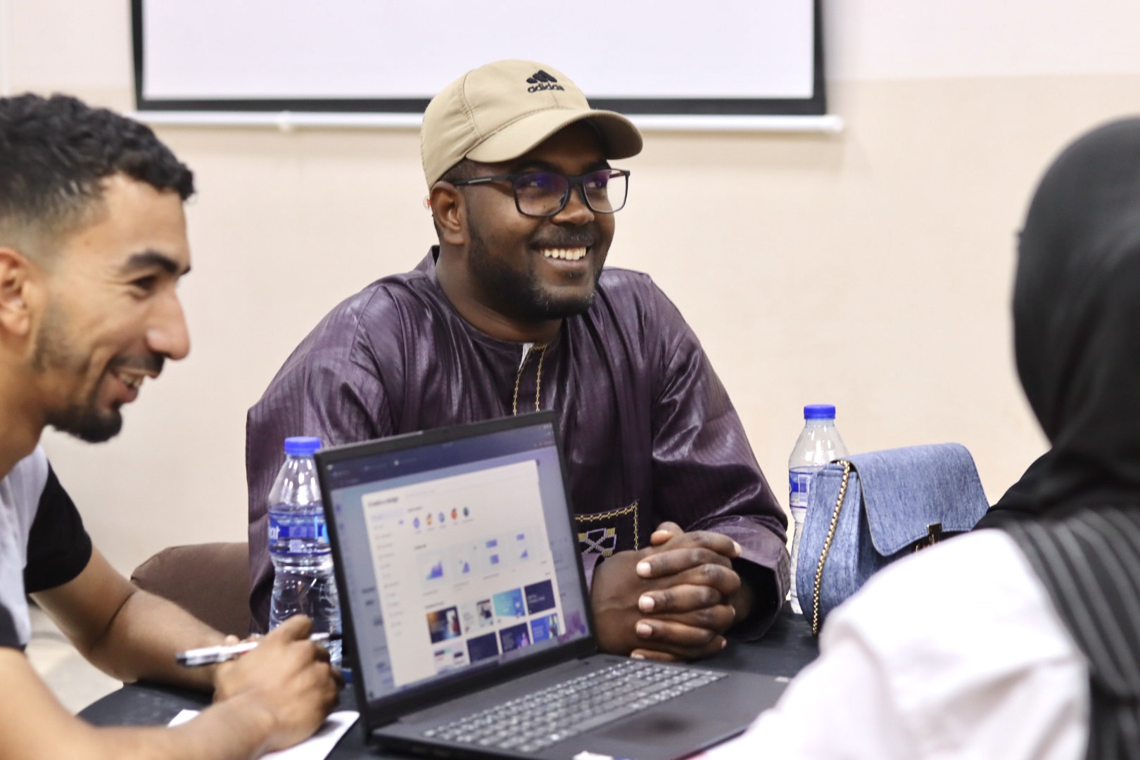 Image of the student teams participating in the Illizi Hackathon 2025, showing team members collaborating in the coworking space to develop innovative solutions for the announced challenge during Global Entrepreneurship Week.