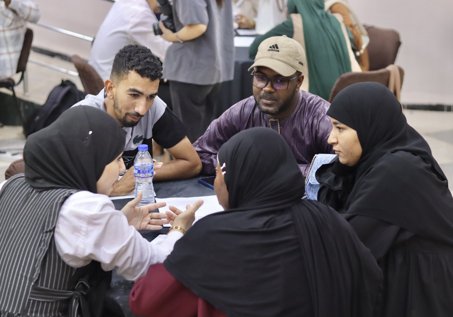 Image of the student teams participating in the Illizi Hackathon 2025, showing team members collaborating in the coworking space to develop innovative solutions for the announced challenge during Global Entrepreneurship Week.