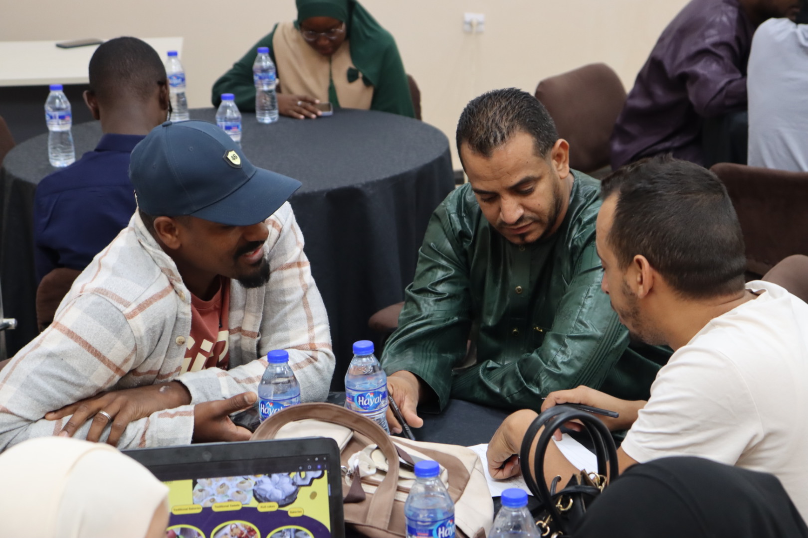 Image of the student teams participating in the Illizi Hackathon 2025, showing team members collaborating in the coworking space to develop innovative solutions for the announced challenge during Global Entrepreneurship Week.