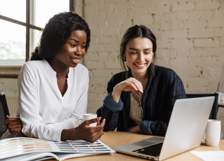 two people looking at computer