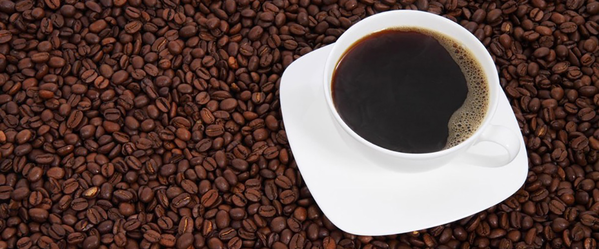 coffee cup on coffee beans