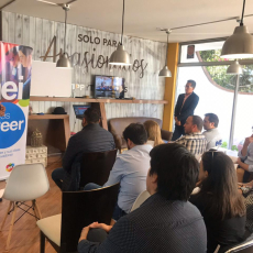 Entrepreneur presents his startup to audience at coworking space in Quito, Ecuador.