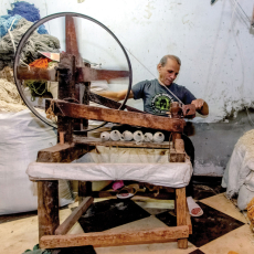 Man spinning thread.