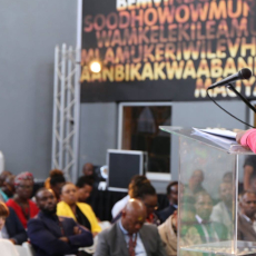 Woman speaking at podium to crowd at 22 On Sloane in Johannesburg, South Africa.