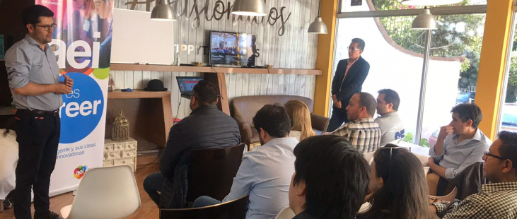 Entrepreneur presents his startup to audience at coworking space in Quito, Ecuador.