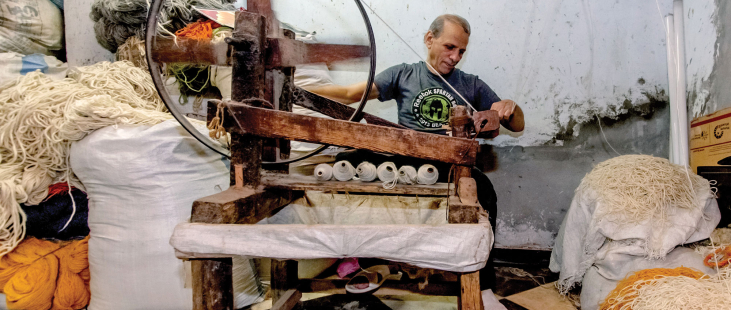 Man spinning thread.