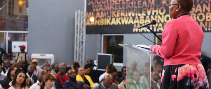 Woman speaking at podium to crowd at 22 On Sloane in Johannesburg, South Africa.