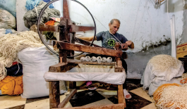 Man spinning thread.