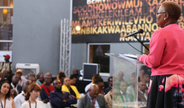 Woman speaking at podium to crowd at 22 On Sloane in Johannesburg, South Africa.