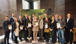 Group of people receiving letters of recognition from Minister of Economics of Latvia