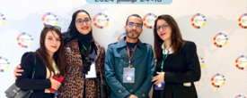 Group of people posing for a photo infront of a wall with the Global Entrepreneurship Week Algeria logo