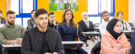 Queen Rania of Jordan sits among a group of students during a Global Entrepreneurship Week event 